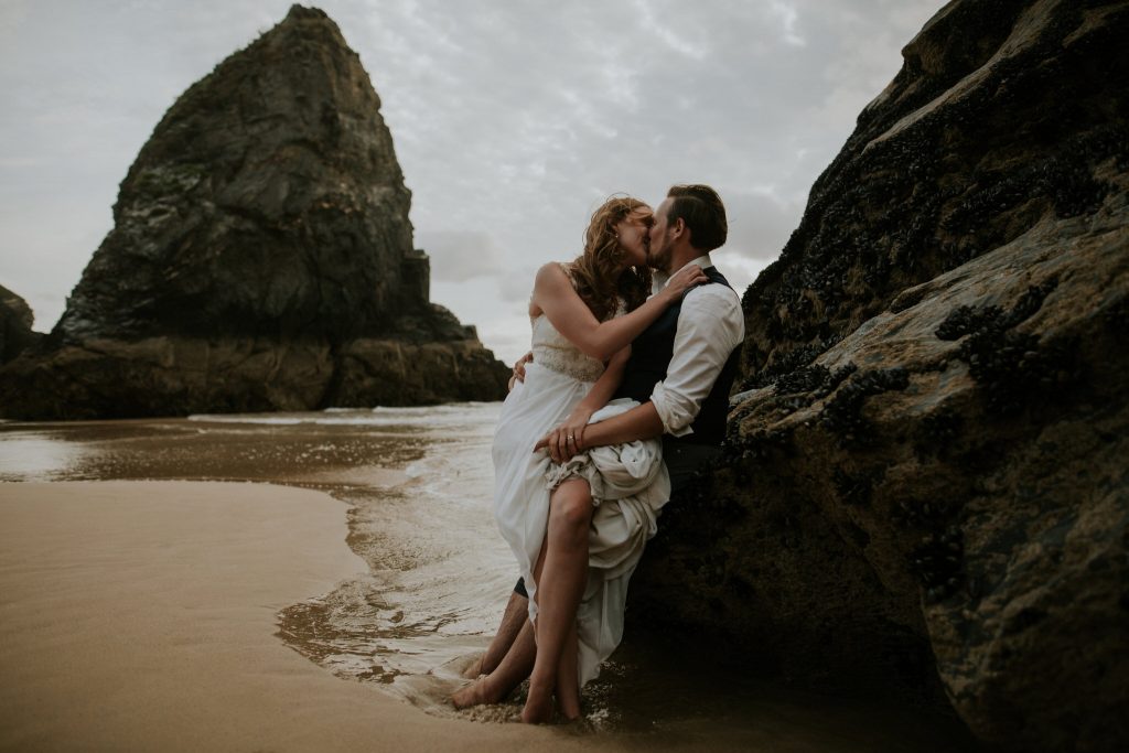 cornwall elopement couple kiss on a sandy beach 